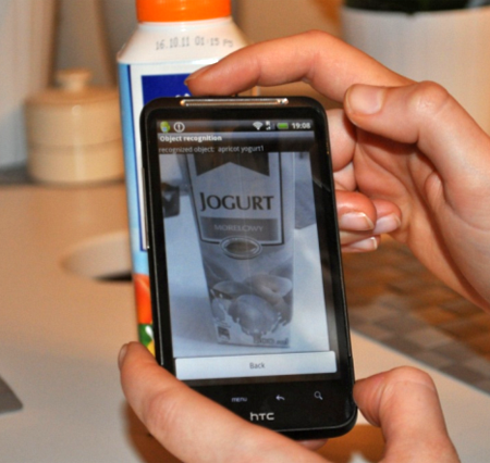 Object recognition application runs on a HTC Smartphone. The application software successfully recognizes the object (apricot yogurt) and displays the reference image.